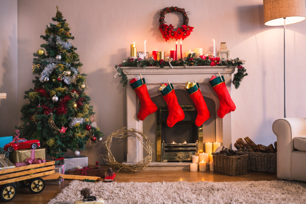 Room decorated for Christmas with a tree stockings, presents, and a wreath. 