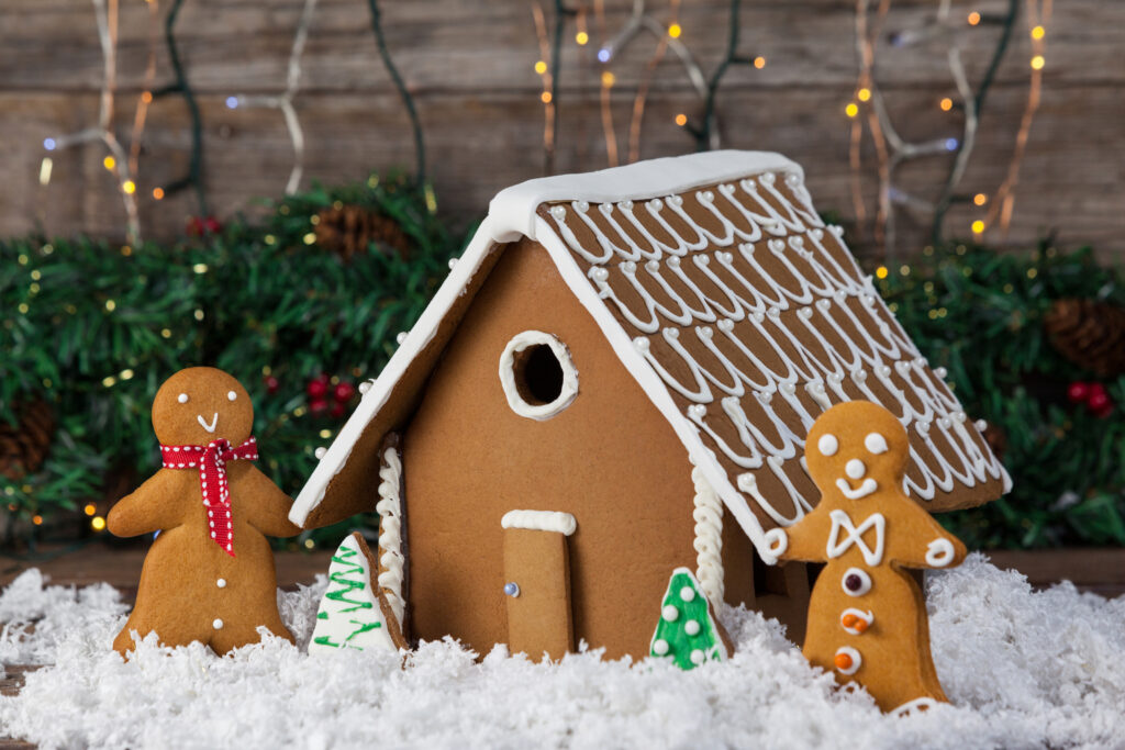 Close up of a decorated gingerbread house with two gingerbread men. 